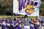 Photo of cheerleaders with WIU flag at a football game