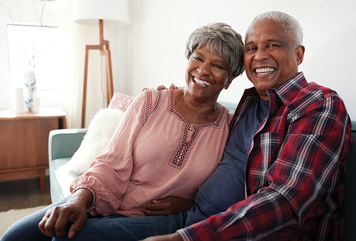 Photo of an older couple smiling.