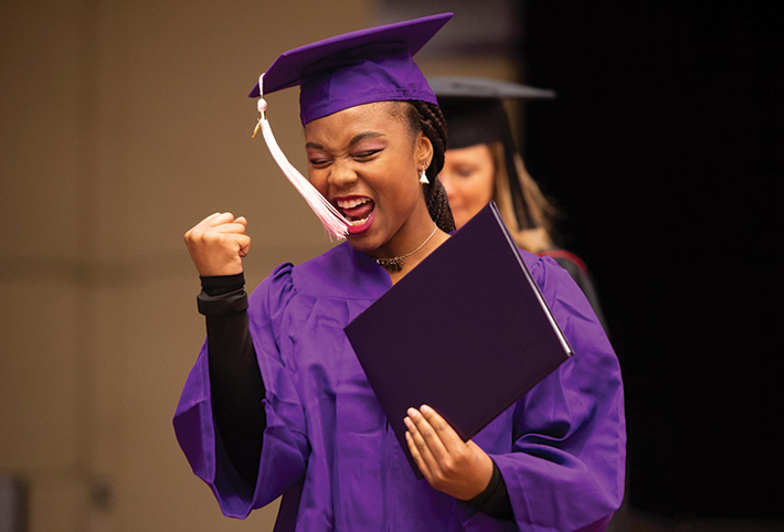 A student celebrating. Link to Closely Held Business Stock.