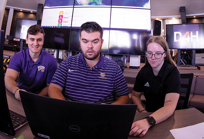 Three students siting in front of computers. Link to What to Give.